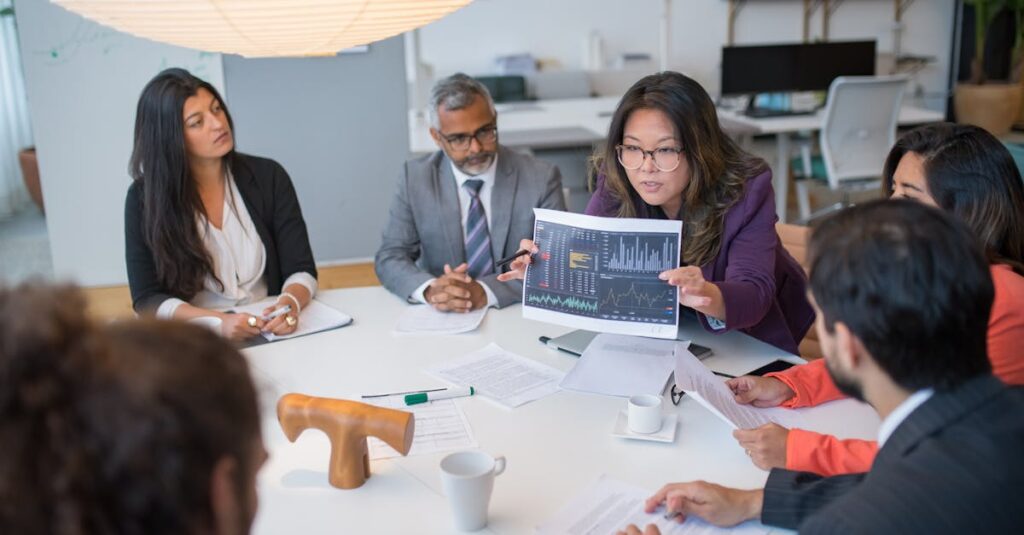 Multicultural team discussing analytics in a professional business meeting setting with data charts.